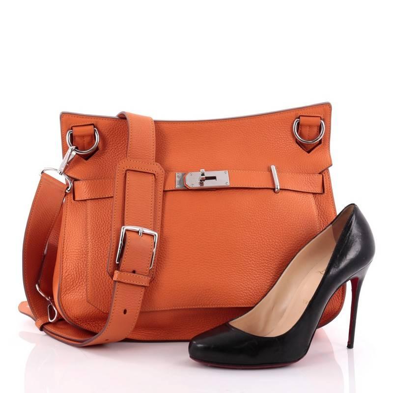 This authentic Hermes Eclat Jypsiere Handbag Clemence 34 is a current and favorite style among Hermes lovers. Inspired by the brand's iconic Kelly bag, this luxurious and industrial messenger is crafted in orange togo leather featuring palladium