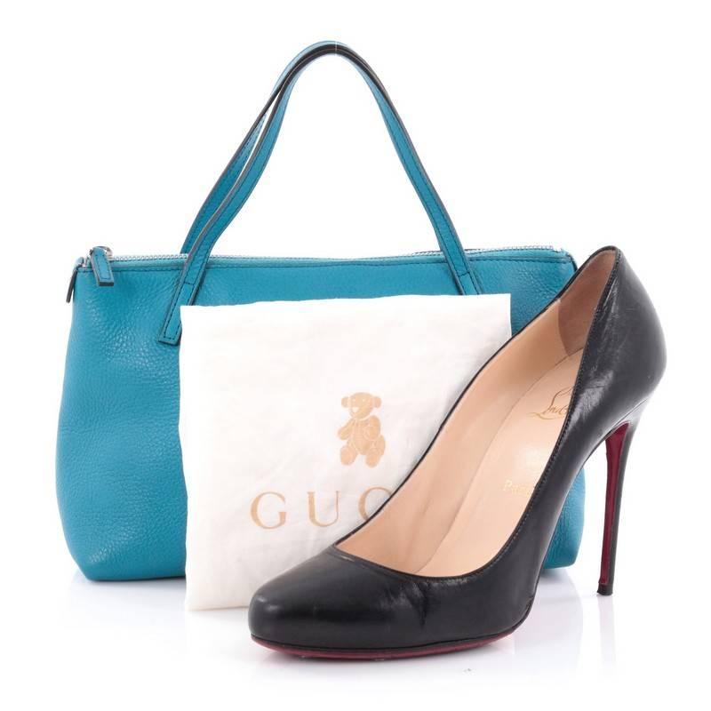 This authentic Gucci Soho Kid's Tote Leather Mini is perfect for daily use and weekend getaways. Crafted from blue leather, this elegant carry-all tote features dual-flat leather handles, stitched interlocking GG logo, and silver-tone hardware