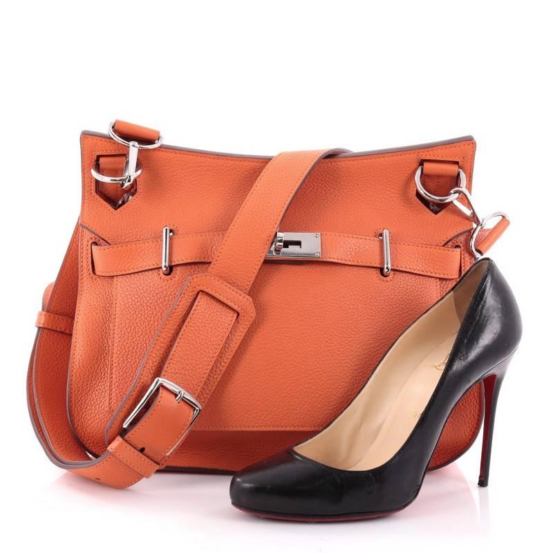 This authentic Hermes Jypsiere Handbag Clemence 31, inspired by the iconic Kelly bag, is a current and favorite style among Hermes lovers. Crafted from orange leather, this luxurious messenger features flat adjustable leather shoulder strap and