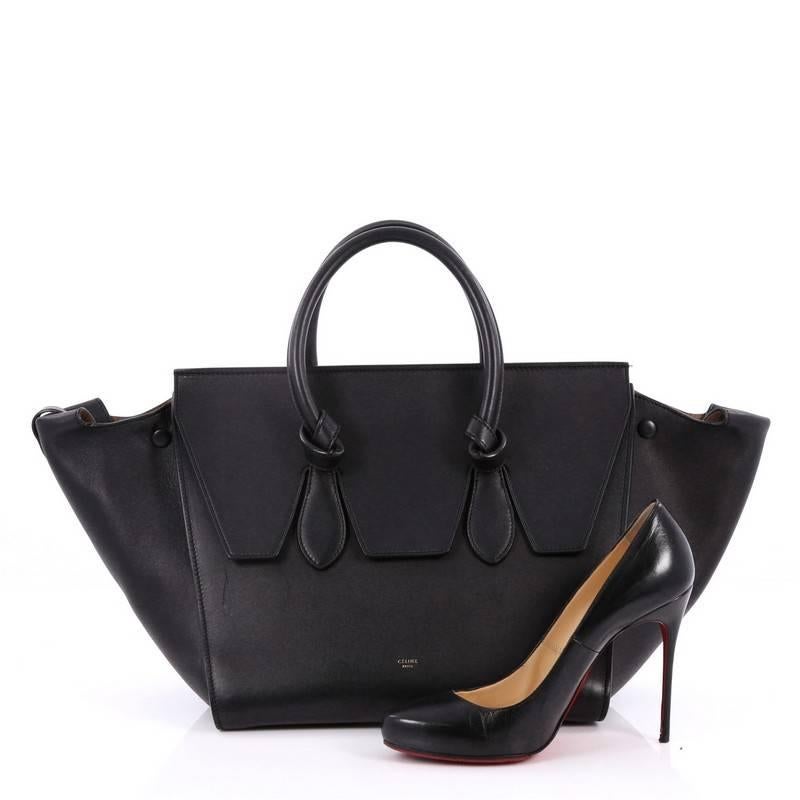 This authentic Celine Tie Knot Tote Smooth Leather Small is an absolute must-have for modern fashionistas. Crafted from black leather, this boxy, chic tote features dual-rolled leather handles with signature knot accents, protective base studs,