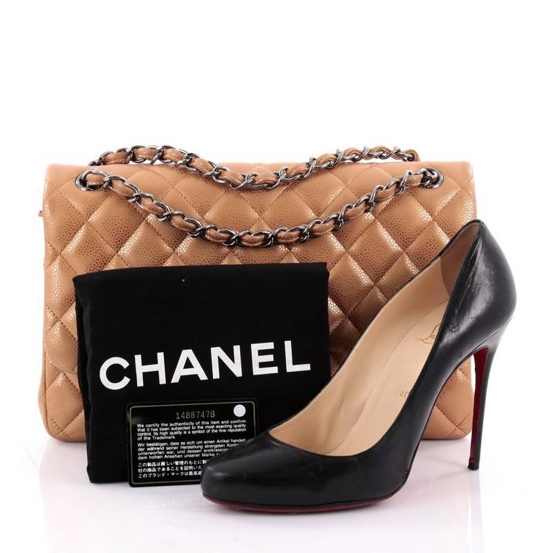 This authentic Chanel Classic Double Flap Bag Quilted Caviar Jumbo exudes a classic yet easy style made for the modern woman. Crafted from metallic bronze caviar leather, this elegant flap features Chanel's signature diamond quilted design, woven-in