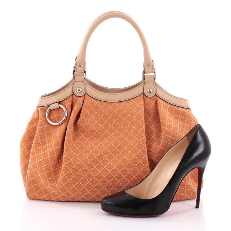 This authentic Gucci Sukey Tote Diamante Canvas Medium is sophisticated in design and modernly chic perfect for casual excursions. Crafted in signature diamond pattern diamante in orange canvas and beige leather trims, this soft, structured bag
