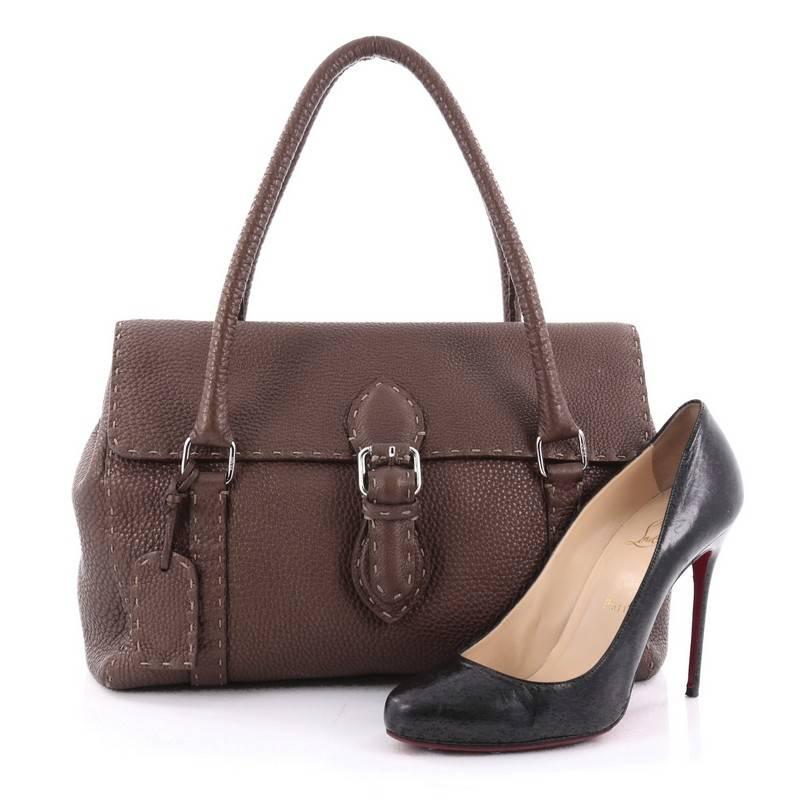 This authentic Fendi Selleria Linda Satchel Pebbled Leather Medium is a classic stylish bag perfect for daily or work excursions. Constructed from brown pebbled leather, this stylish satchel features dual-rolled leather handles, hand stitched saddle