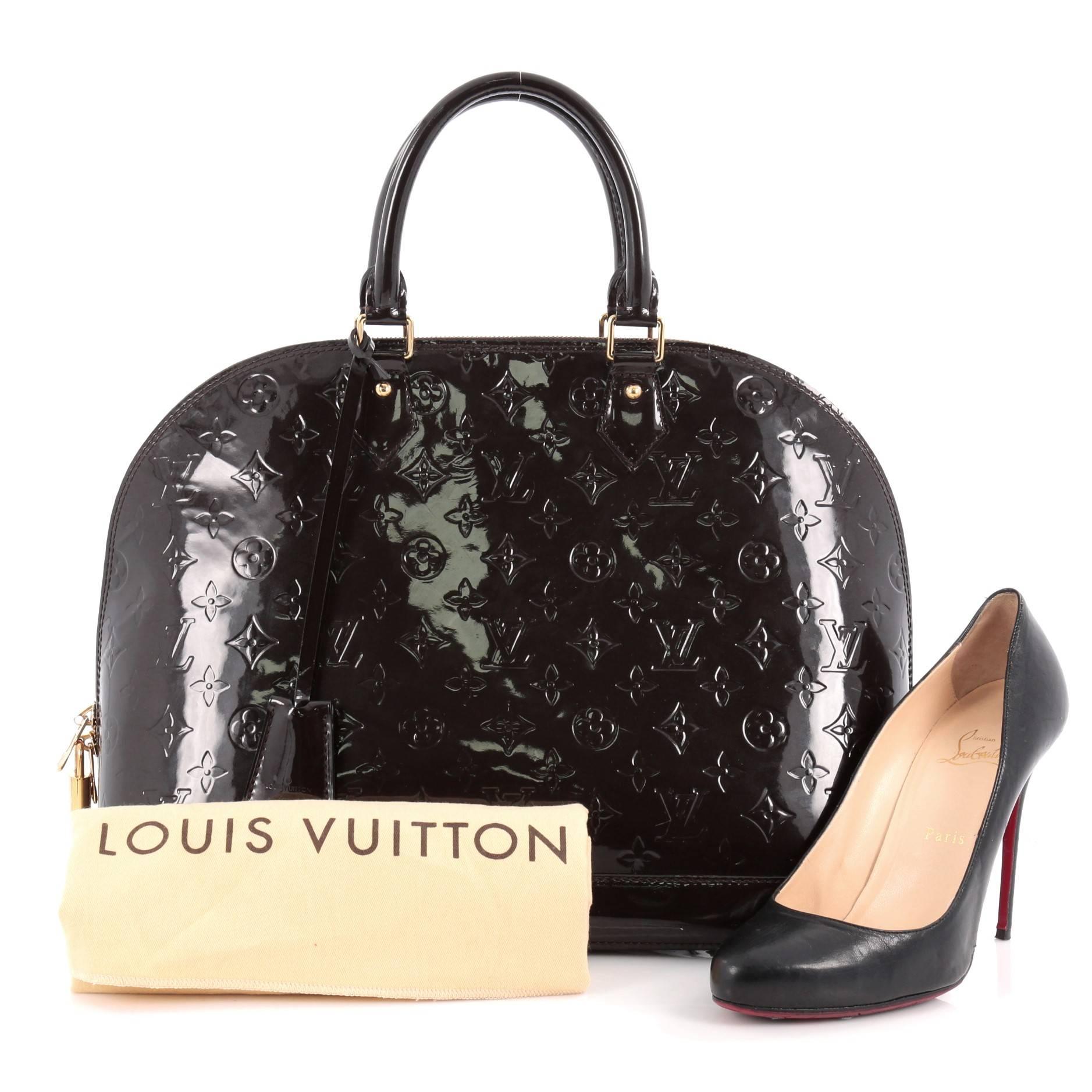 This authentic Louis Vuitton Alma Handbag Monogram Vernis GM is a fresh and elegant spin on a classic style that is perfect for all seasons. Crafted from Louis Vuitton's dark brown monogram vernis, this dome-shaped satchel features double rolled