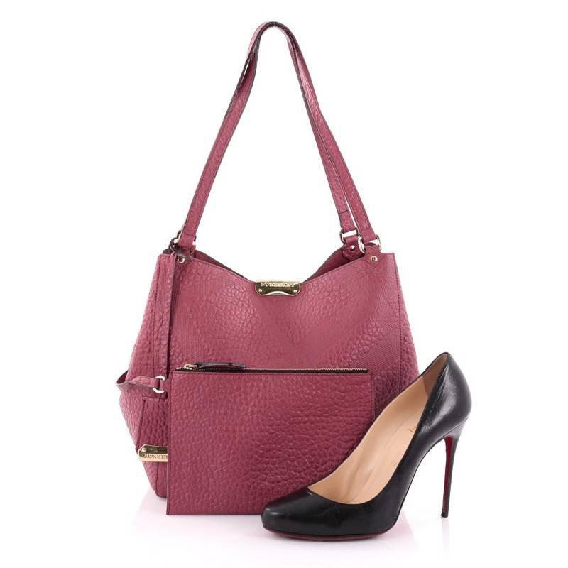 This authentic Burberry Canterbury Tote Embossed Check Leather Small is the perfect daily accessory for any modern woman. Crafted from dark pink check-embossed signature grained leather, this tote features dual flat leather shoulder straps,
