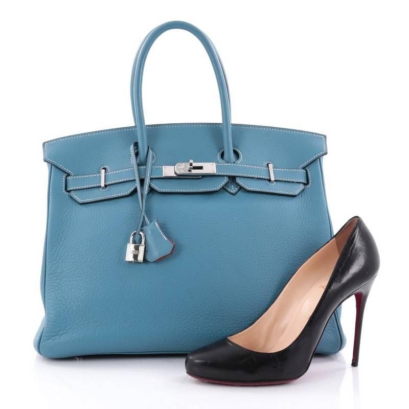 This authentic Hermes Birkin Handbag Bicolor Clemence with Palladium Hardware 35 stands as one of the most-coveted bags. Constructed from scratch-resistant, iconic blue jean clemence leather, this stand-out tote features dual-rolled top handles,