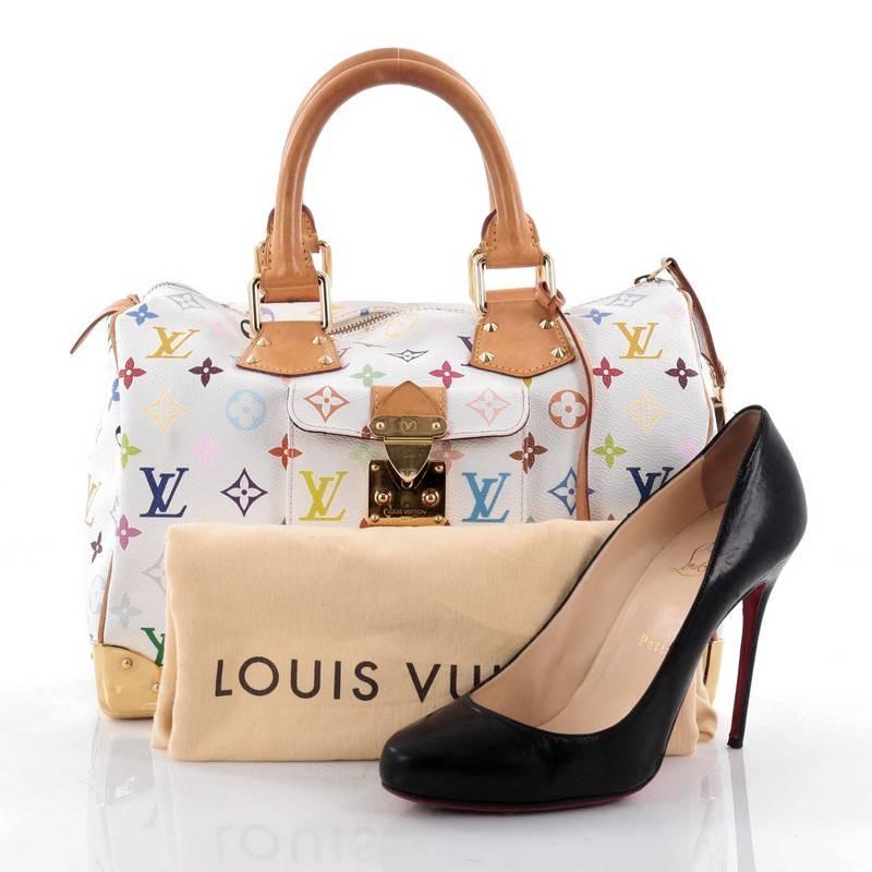 This authentic Louis Vuitton Speedy Handbag Monogram Multicolor 30 is vibrant and elegant, made for a sophisticated travelling fashionista. Crafted from Louis Vuitton’s signature white monogram multicolor coated canvas, this iconic bag features