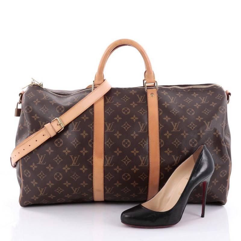 This authentic Louis Vuitton Keepall Bandouliere Bag Monogram Canvas 50 is the perfect purchase for a weekend trip, and can be effortlessly paired with any outfit from casual to formal. Crafted from traditional Louis Vuitton brown monogram coated