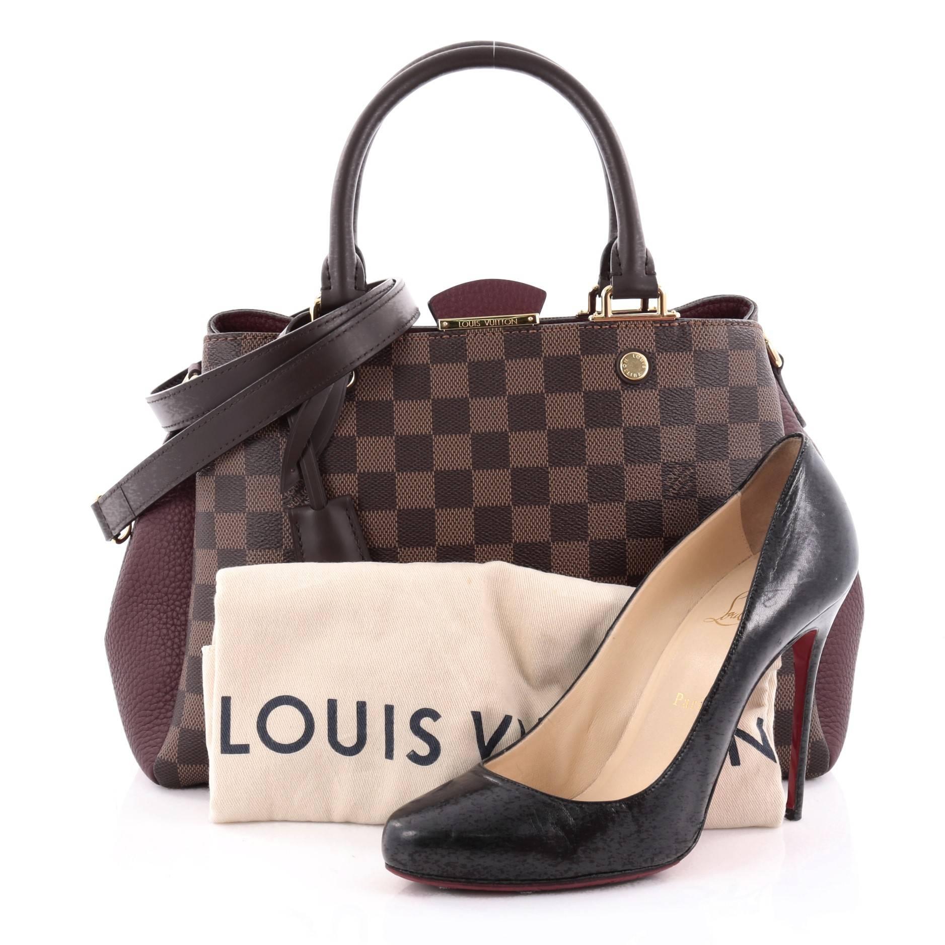 This authentic Louis Vuitton Brittany Handbag Damier makes an elegant statement with its contrast pairing. Crafted from damier ebene coated canvas and maroon Taurillon leather, this sophisticated and feminine bag features dual-rolled leather