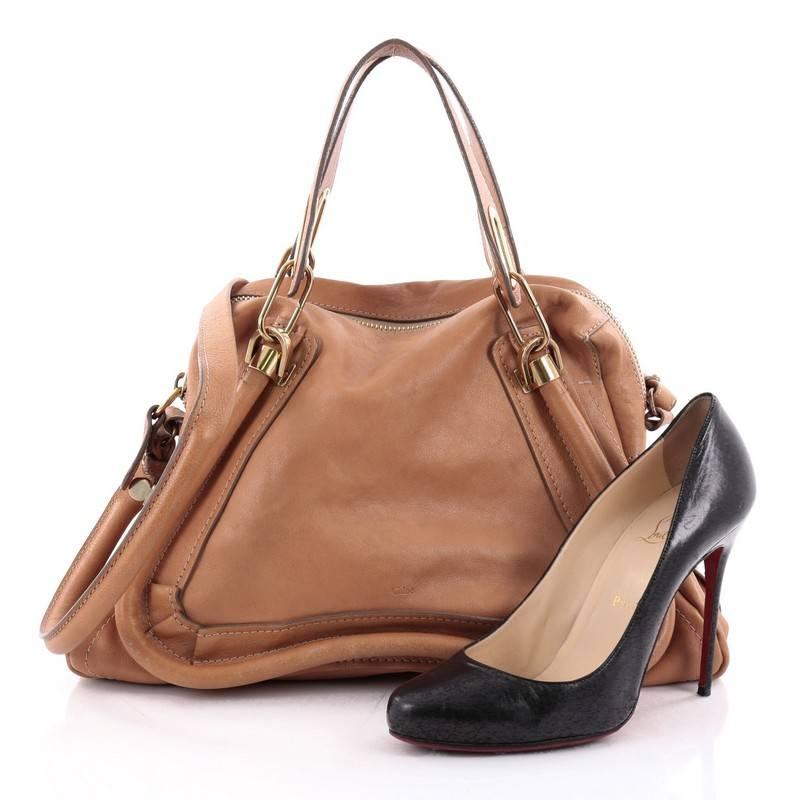 This authentic Chloe Paraty Top Handle Bag Leather Medium mixes everyday style and functionality perfect for the modern woman. Crafted from camel brown leather, this versatile bag features dual flat handles, piped trim details, side twist locks, and