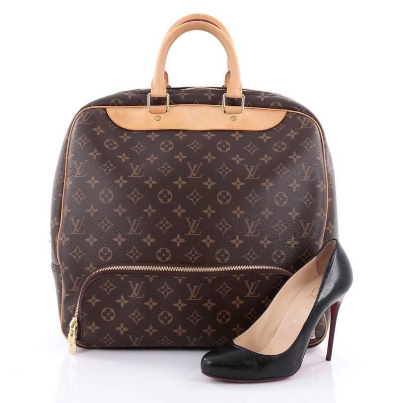 This authentic Louis Vuitton Evasion Travel Bag Monogram Canvas MM is your ideal weekend getaway bag. Crafted from brown monogram coated canvas, this compact size travel bag features dual-rolled leather handles, natural vachetta leather trims,
