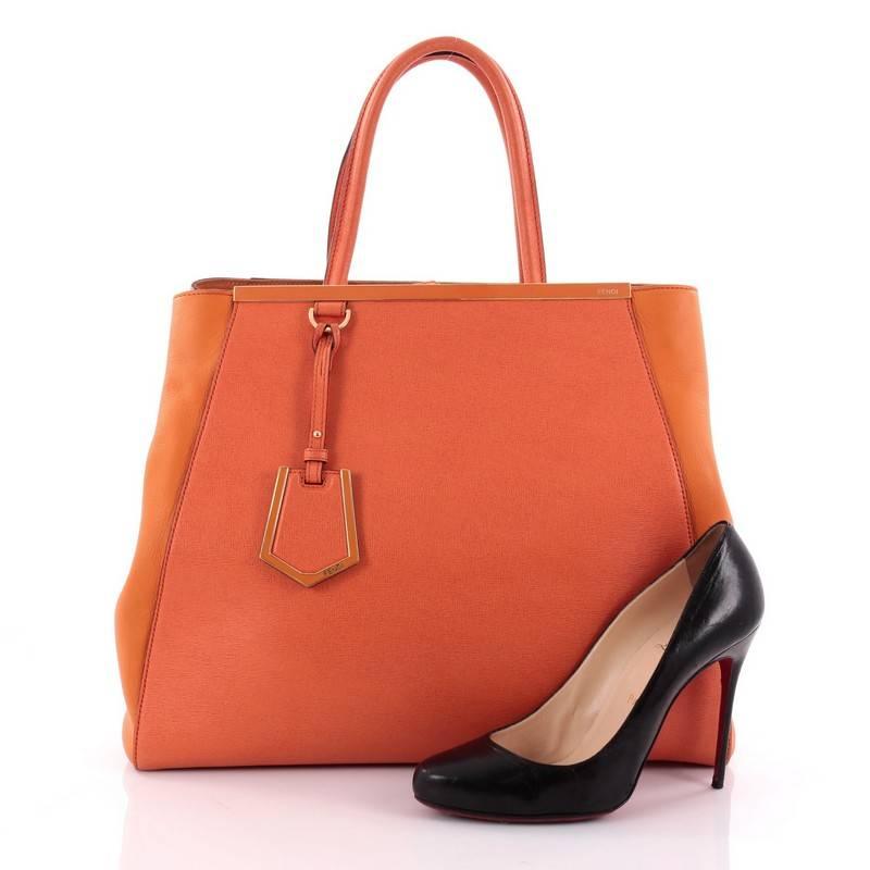 This authentic Fendi 2Jours Handbag Leather Large is impeccably stylish bag perfect for your everyday looks. Crafted in orange leather with smooth side wings, this popular tote features dual-rolled leather handles, accented with a shining top bar