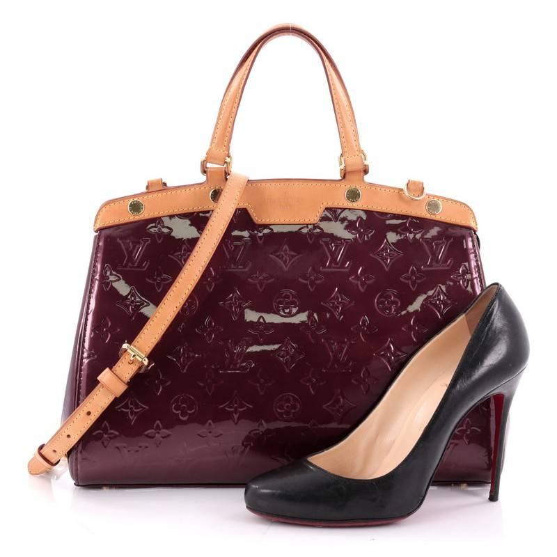This authentic Louis Vuitton Brea Handbag Monogram Vernis MM is a staple for an everyday casual look. Crafted in violette monogram vernis leather with cowhide leather trims, this structured yet feminine tote features dual flat handles, stand-out