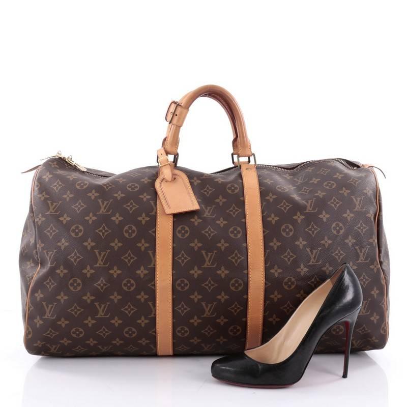 This authentic Louis Vuitton Keepall Bag Monogram Canvas 55 is the perfect purchase for a weekend trip, and can be effortlessly paired with any outfit from casual to formal. Crafted with traditional Louis Vuitton monogram coated canvas, this classic