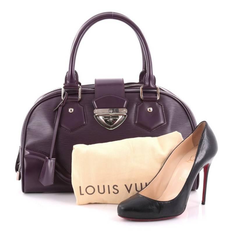 This authentic Louis Vuitton Montaigne Bowling Bag Epi Leather GM is perfect for everyday use. Crafted from purple epi leather, this structured bowler features dual-rolled leather handles, protective base studs and silver-tone hardware accents. Its
