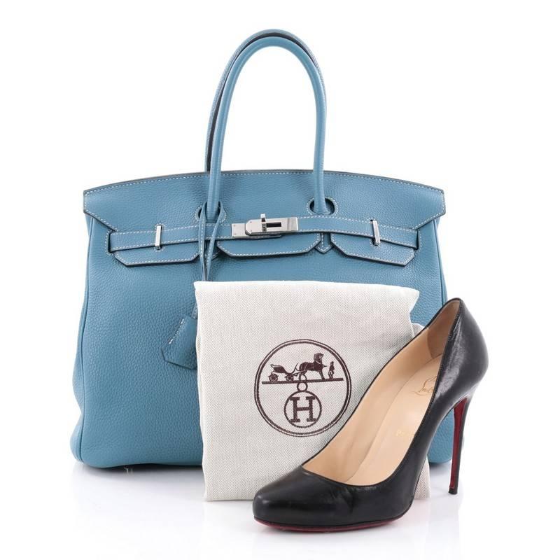 This authentic Hermes Birkin Handbag Blue Jean Togo with Palladium Hardware 35 stands as one of the most-coveted bags. Constructed from scratch-resistant, iconic blue togo leather, this stand-out tote features dual-rolled top handles, frontal flap,