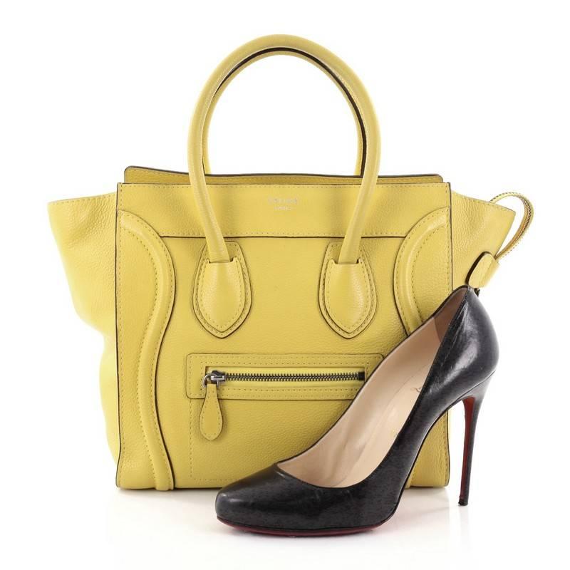 This authentic Celine Luggage Handbag Grainy Leather Micro is one of the most sought-after bags beloved by fashionistas. Crafted from yellow grainy leather, this minimalist tote features dual-rolled handles, an exterior front pocket, protective base