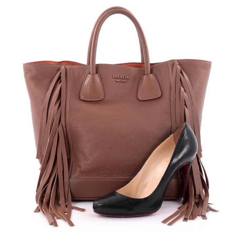 This authentic Prada Side Fringe Tote Cervo Leather Medium presented in the brand's 2013 Collection combines classic and easy style with a chic twist perfect for daily excursions. Crafted from brown cervo leather, this 70s-inspired, stylish tote