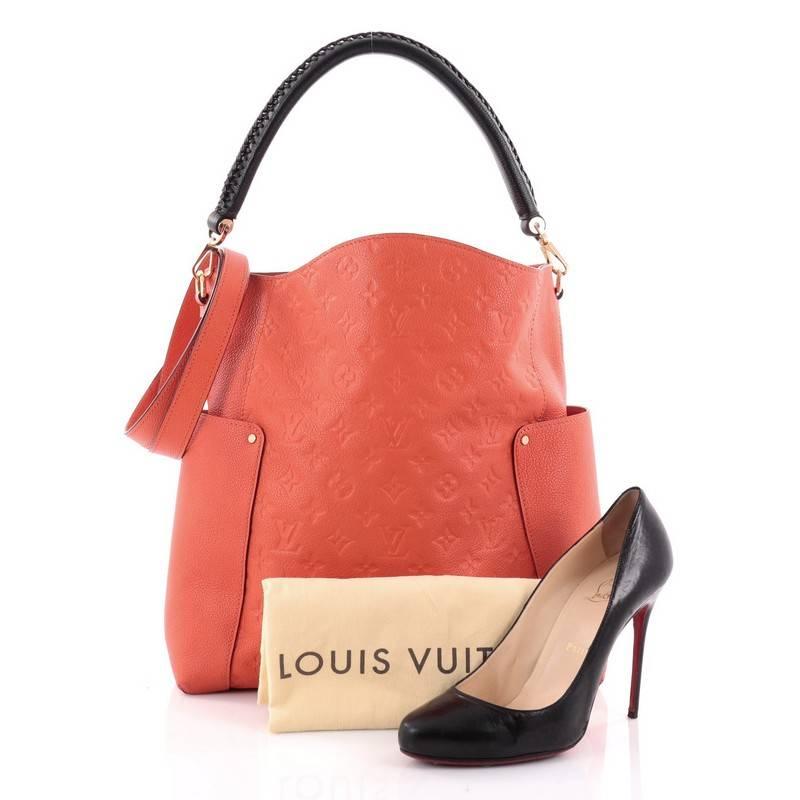 This authentic Louis Vuitton Bagatelle Hobo Monogram Empreinte Leather is a versatile and chic bag perfect for your everyday looks. Crafted from dark orange monogram empreinte leather with leather trims, this luxurious hobo features a braided