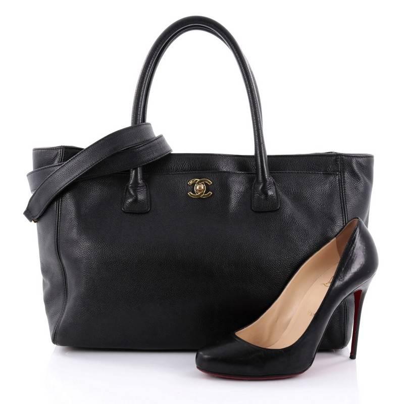 This authentic Chanel Cerf Executive Tote Leather Medium is an ideal everyday accessory for the modern woman. Crafted from beautiful black leather, this classic and functional tote features dual-rolled tall handles, front pocket with CC turn-lock