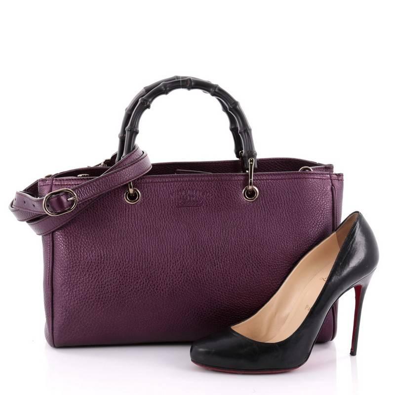 This authentic Gucci Bamboo Shopper Tote Leather Medium is a classic must-have. Crafted from purple mettalic leather, this simple yet stylish tote features Gucci's signature sturdy bamboo handles, protective base studs, stamped logo at the front,