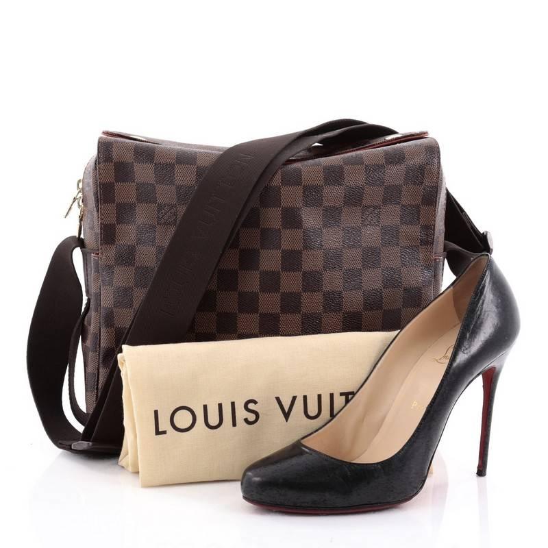 This authentic Louis Vuitton Naviglio Handbag Damier is perfect for the style-conscious man or woman on the go. Crafted from brown ebene coated canvas, this elegant bag features wide canvas adjustable strap, large dual flap design and gold-tone