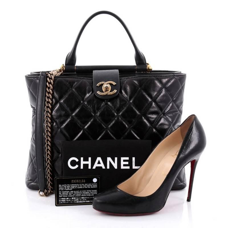 This authentic Chanel Gold Bar Tote Quilted Aged Calfskin is a versatile bag ideal for day or evening wear with a timeless style. Crafted from black quilted aged calfskin leather, this bag features sturdy bar frame at the top with an attached rolled