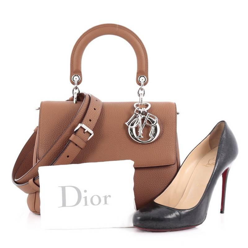 This authentic Christian Dior Be Dior Bag Pebbled Leather Small is both bold and beautiful, perfect for every fashionista. Crafted from brown leather, this boxy bag features leather handle with sleek silver Dior charms, side snap buttons, exterior