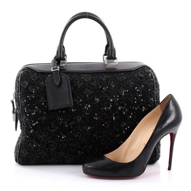 This authentic Louis Vuitton Speedy Handbag Limited Edition Sunshine Express 30 presented at the brand's Fall/Winter 2012 Collection is a glittery twist on the classic speedy design. Crafted from black fabric with embroidered luminous sequins, this