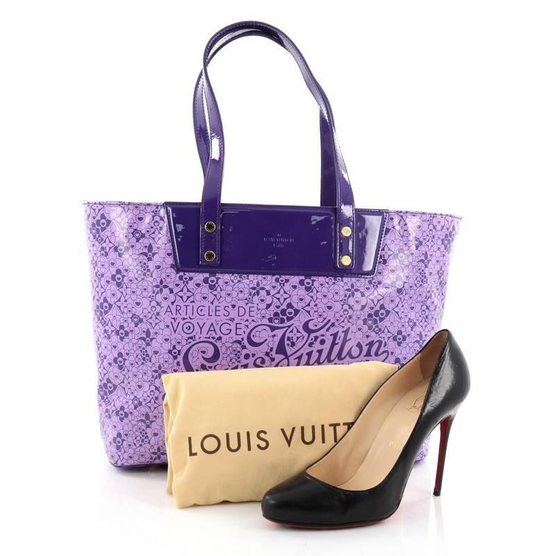 This authentic Louis Vuitton Voyage Tote Cosmic Blossom PM is a limited edition, unique piece that has a glossy and vibrant color. Crafted from purple patent leather with cosmic monogram flower prints created by Japanese artist Takashi Murakami,
