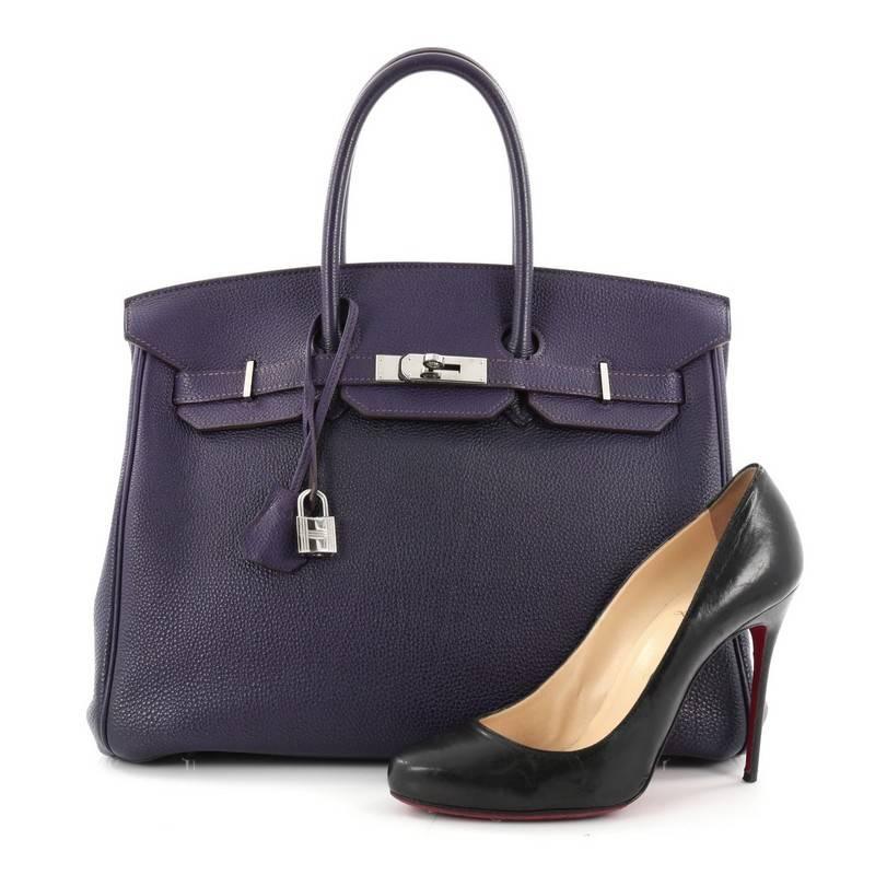 This authentic Hermes Birkin Handbag Iris Togo with Palladium Hardware 35 stands as one of the most-coveted accessory made for the modern woman. Crafted from iris purple leather, this stand-out tote features dual-rolled top handles, frontal flap,