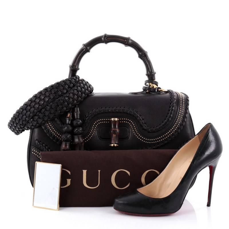 This authentic Gucci New Bamboo Top Handle Bag Studded Leather Large is unmistakably a classic Gucci design. Crafted from black leather, this iconic handle bag features a looped bamboo top handle, detachable woven shoulder strap, bamboo turn-lock