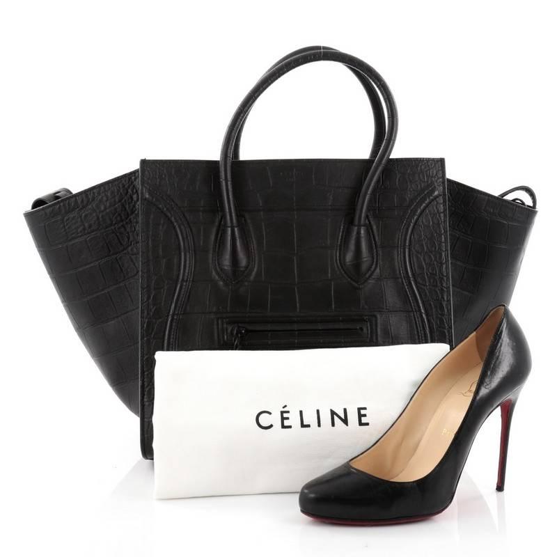 This authentic Celine Phantom Handbag Crocodile Embossed Leather Medium is one of the most sought-after bags beloved by fashionistas. Crafted from black crocodile embossed leather, this minimalist tote features dual-rolled handles, an exterior front