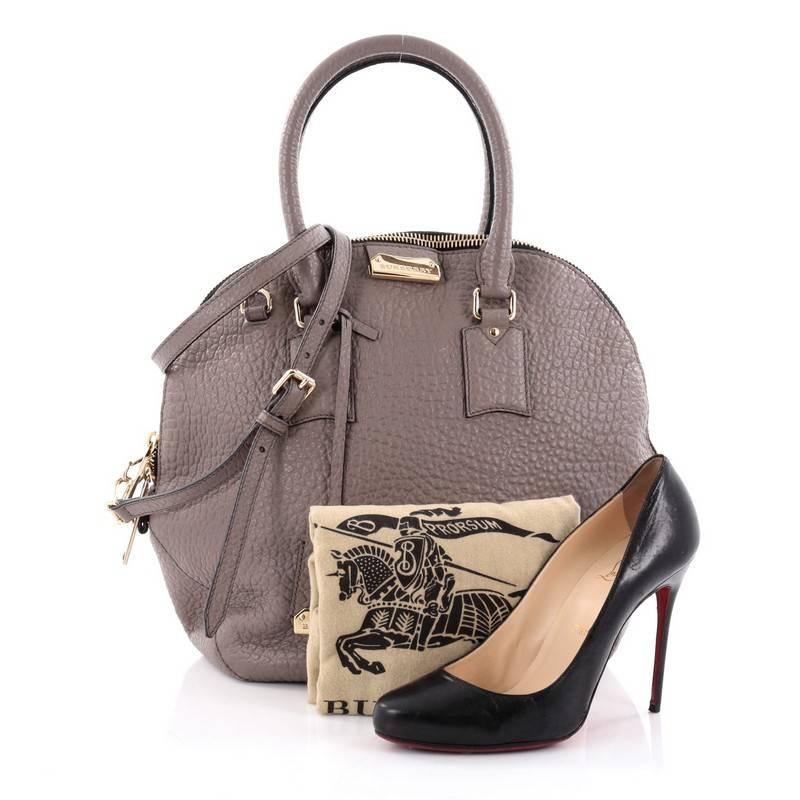 This authentic Burberry Orchard Bag Heritage Grained Leather Medium has a glamorous design with a roomy silhouette that is ideal for everyday use. Crafted from grey grainy leather, this vintage-inspired bag features dual-rolled leather handles,