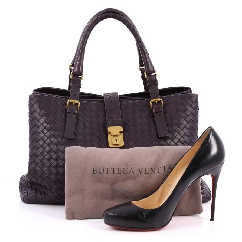 This authentic Bottega Veneta Roma Handbag Intrecciato Nappa Medium is a finely crafted tote that exudes an understated elegance. Crafted from dark purple nappa leather woven in Bottega Veneta's signature intrecciato method, it features dual woven