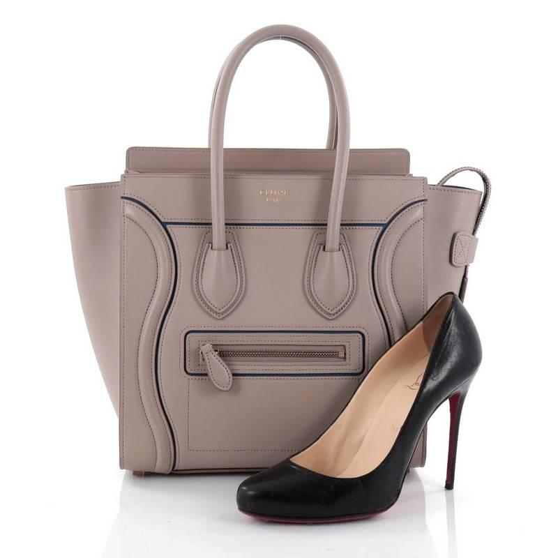 This authentic Celine Luggage Handbag Smooth Leather Micro is the quintessential It bag perfect for the modern woman. Crafted in taupe smooth leather, this popular tote features gold Celine logo detail, dual-rolled leather handles, front zipped