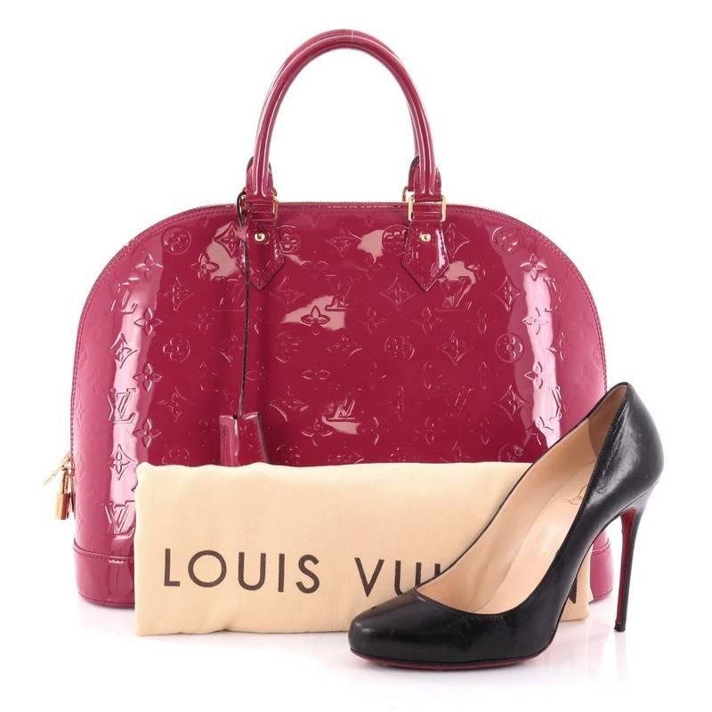 This authentic Louis Vuitton Alma Handbag Monogram Vernis GM is a fresh and elegant spin on a classic style that is perfect for all seasons. Crafted from Louis Vuitton's pink monogram vernis, this dome-shaped satchel features dual-rolled handles,