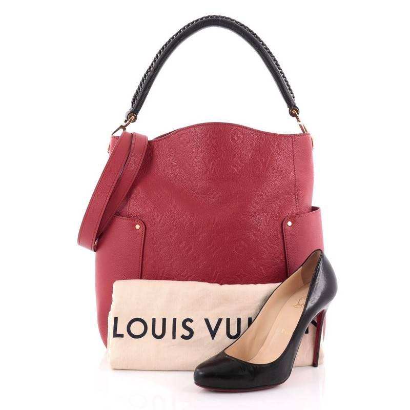 This authentic Louis Vuitton Bagatelle Hobo Monogram Empreinte Leather is a versatile and chic bag perfect for your everyday looks. Crafted from red monogram empreinte leather with leather trims, this luxurious hobo features a braided handle,