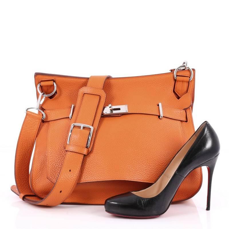 This authentic Hermes Jypsiere Handbag Togo 34 is a current and favorite style among Hermes lovers. Inspired by the brand's iconic Kelly bag, this luxurious and industrial messenger is crafted in scratch-resistant orange leather featuring palladium