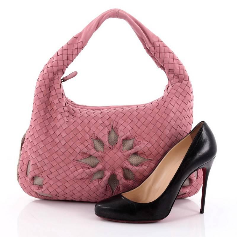 This authentic Bottega Veneta Veneta Hobo Cut Out Intrecciato Nappa Medium is a timelessly elegant accessory with a casual silhouette. Crafted from pink nappa leather woven in Bottega Veneta's signature intrecciato method, this effortless, exquisite