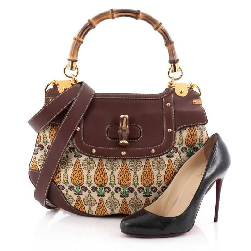 This authentic Gucci Bamboo Convertible Satchel Pigna Canvas with Studded Leather Medium is signature bag perfect for your daily excursions. Crafted from beige canvas 