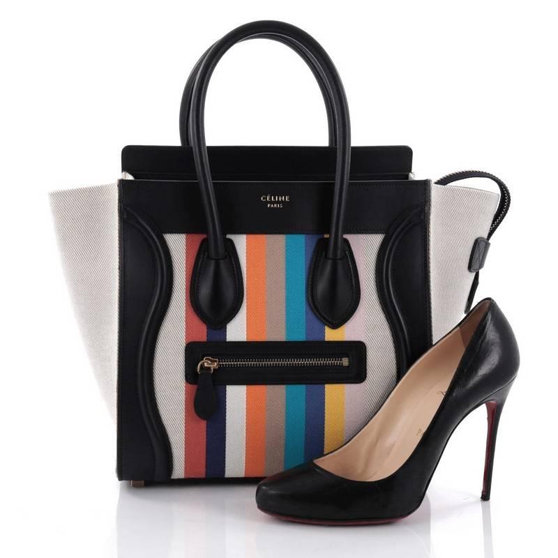 This authentic Celine Luggage Handbag Canvas and Leather Micro presented in the brand's Spring/Summer 2015 Collection is quintessential It bag beloved by many fashionistas. Constructed in multicolored rainbow striped canvas and navy blue leather