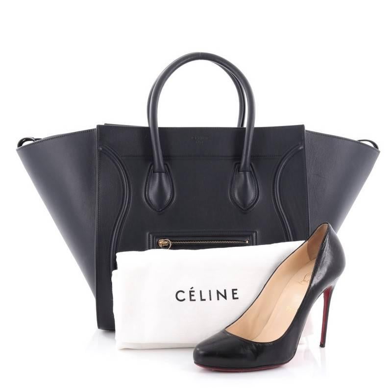 This authentic Celine Phantom Handbag Smooth Leather Medium is one of the most sought-after bags beloved by fashionistas. Crafted from navy blue smooth leather, this minimalist tote features dual-rolled handles, an exterior zip pocket with braided