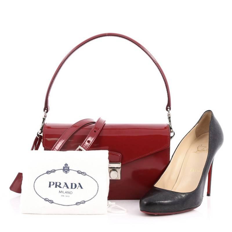 This authentic Prada Sound Bag Spazzolato Leather Small is your perfect fall accessory. Crafted in red spazzolato leather, this chic flap features frontal flap with silver press-lock closure, accordion sides, single loop leather handle which you can