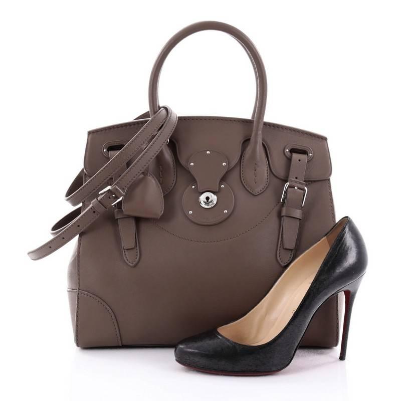 This authentic Ralph Lauren Collection Soft Ricky Handbag Leather 33 is one of the brand's most beloved styles. Crafted from brown leather, this understated, elegant tote features a boxy silhouette, a folded top with a slide-lock clasp and belted