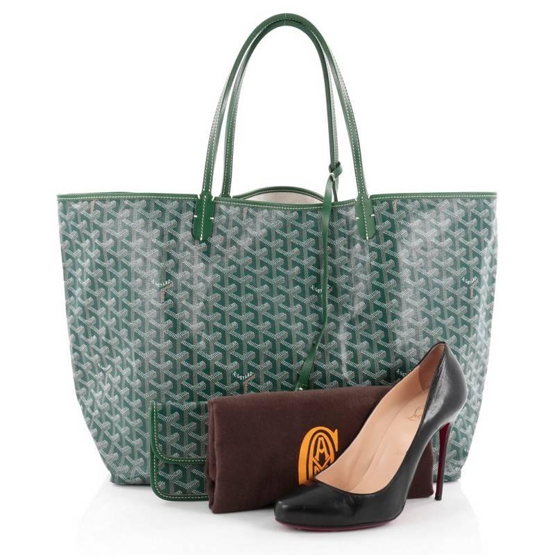 This authentic Goyard St. Louis Tote Coated Canvas GM showcases a modern style perfect for any on-the-go moments. Crafted from the popular and traditional green Goyard chevron printed coated canvas, this spacious tote features long, thin rolled