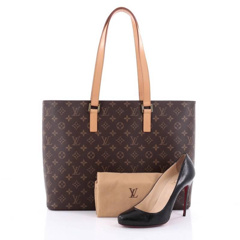 This authentic Louis Vuitton Luco Handbag Monogram Canvas is a classic tote that displays fashion and functionality all rolled into one. Crafted with the brand's iconic brown monogram coated canvas, this tote features dual flat leather handles, a