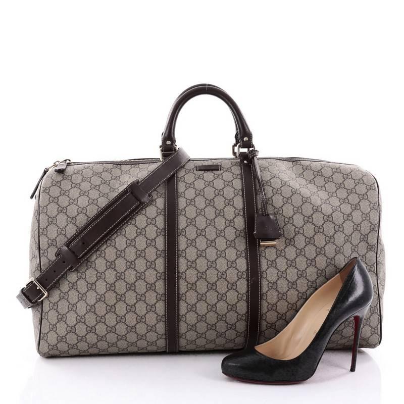 This authentic Gucci Carry On Convertible Duffle Bag GG Coated Canvas Medium is a classic travel bag with a youthful twist made for weekend getaways and light travels. Crafted from taupe GG coated canvas, this duffle features dual-rolled leather