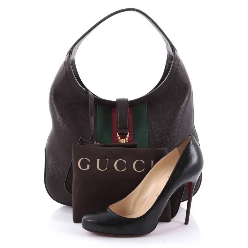 This authentic Gucci Jackie Web Hobo Soft Leather is a must-have shoulder bag fit for the modern woman. Constructed from dark brown soft leather, this bag features looping shoulder strap, signature middle green and red web stripes and aged gold-tone