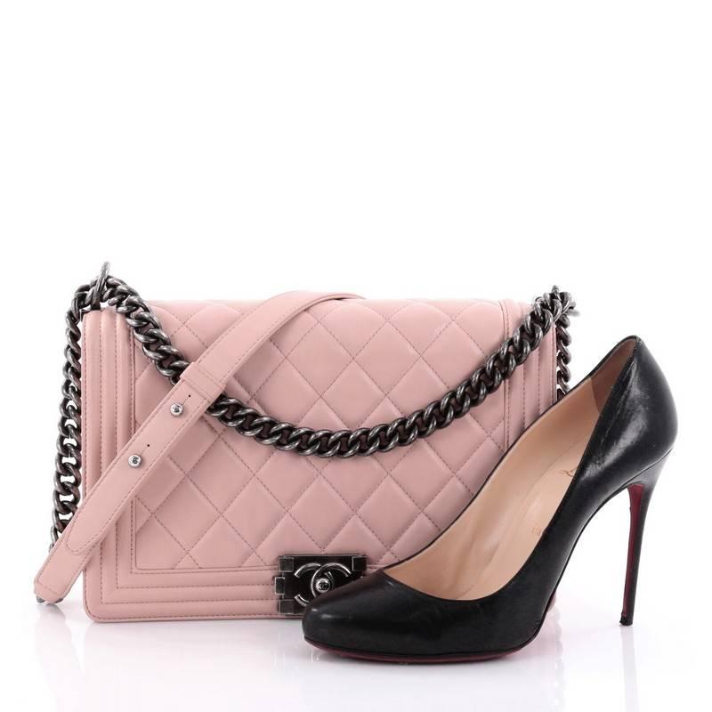 This authentic Chanel Boy Flap Bag Quilted Lambskin New Medium is every woman's dream. Crafted from light pink diamond quilted lambskin leather, this enviable Boy flap bag features a chunky chain link strap with shoulder pad, CC Boy logo push-lock